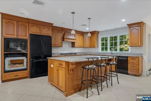 a kitchen with stainless steel appliances granite countertop a stove and a refrigerator