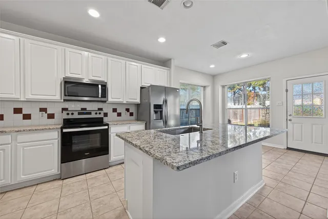 a kitchen with stainless steel appliances granite countertop a stove and a sink