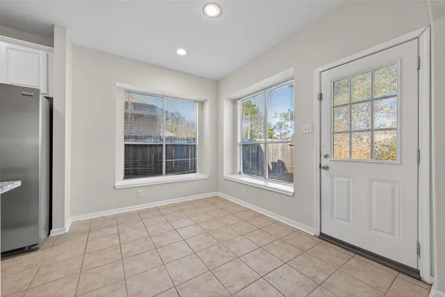 an empty room with windows and closet
