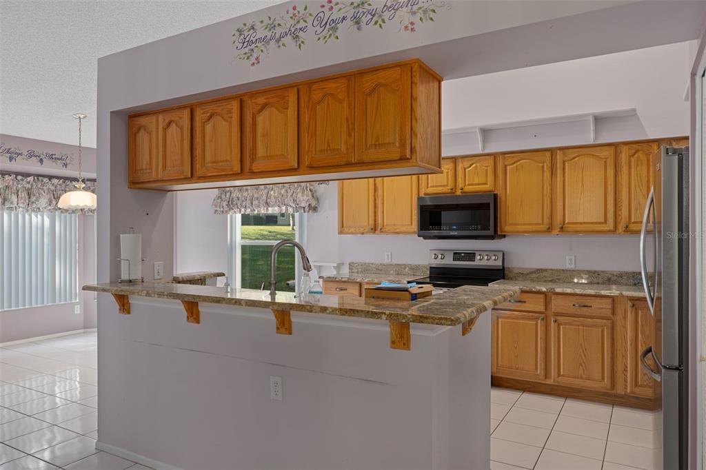 2321 Terrace View Lane Spring Hill, FL 34606 - Photo 12 of 41 a kitchen with a sink a stove and cabinets