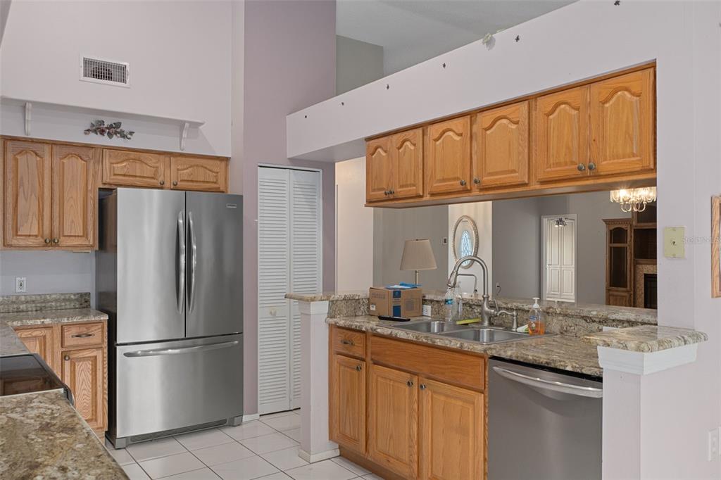 2321 Terrace View Lane Spring Hill, FL 34606 - Photo 14 of 41 a kitchen with stainless steel appliances granite countertop a refrigerator and a sink
