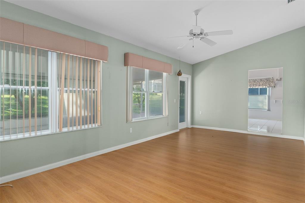 2321 Terrace View Lane Spring Hill, FL 34606 - Photo 18 of 41 a view of an empty room with a window and wooden floor