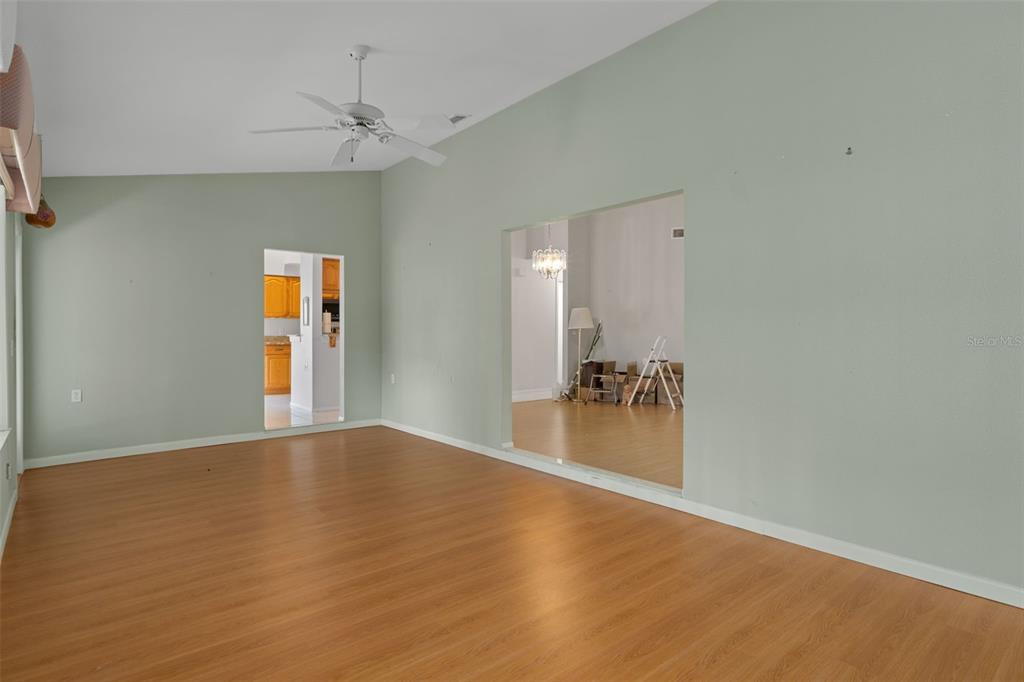 2321 Terrace View Lane Spring Hill, FL 34606 - Photo 19 of 41 a view of a livingroom with a ceiling fan and wooden floor