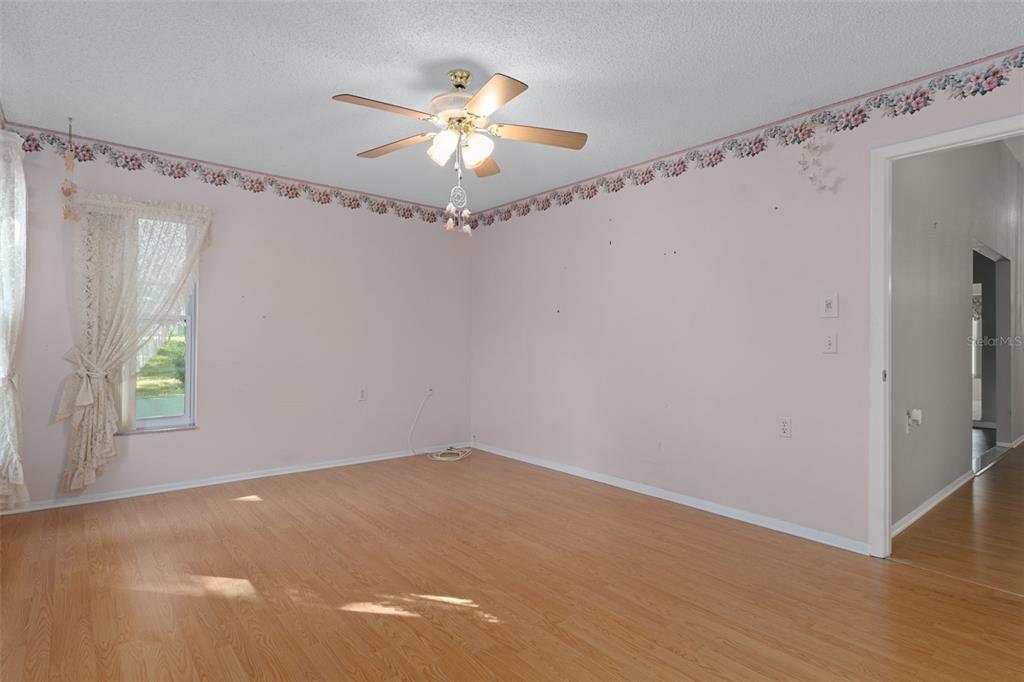 2321 Terrace View Lane Spring Hill, FL 34606 - Photo 25 of 41 an empty room with windows and fan