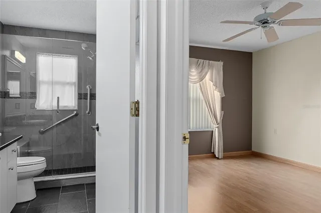 a view of a hallway and a livingroom with furniture