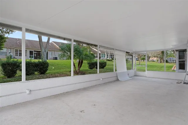 a view of a house with a yard and large tree