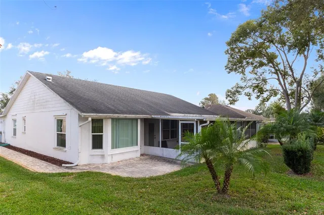a backyard of a house with table and chairs