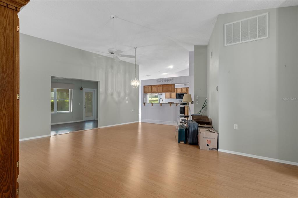 2321 Terrace View Lane Spring Hill, FL 34606 - Photo 7 of 41 a view of empty room with wooden floor and windows