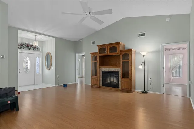 a view of an empty room with window and fire place