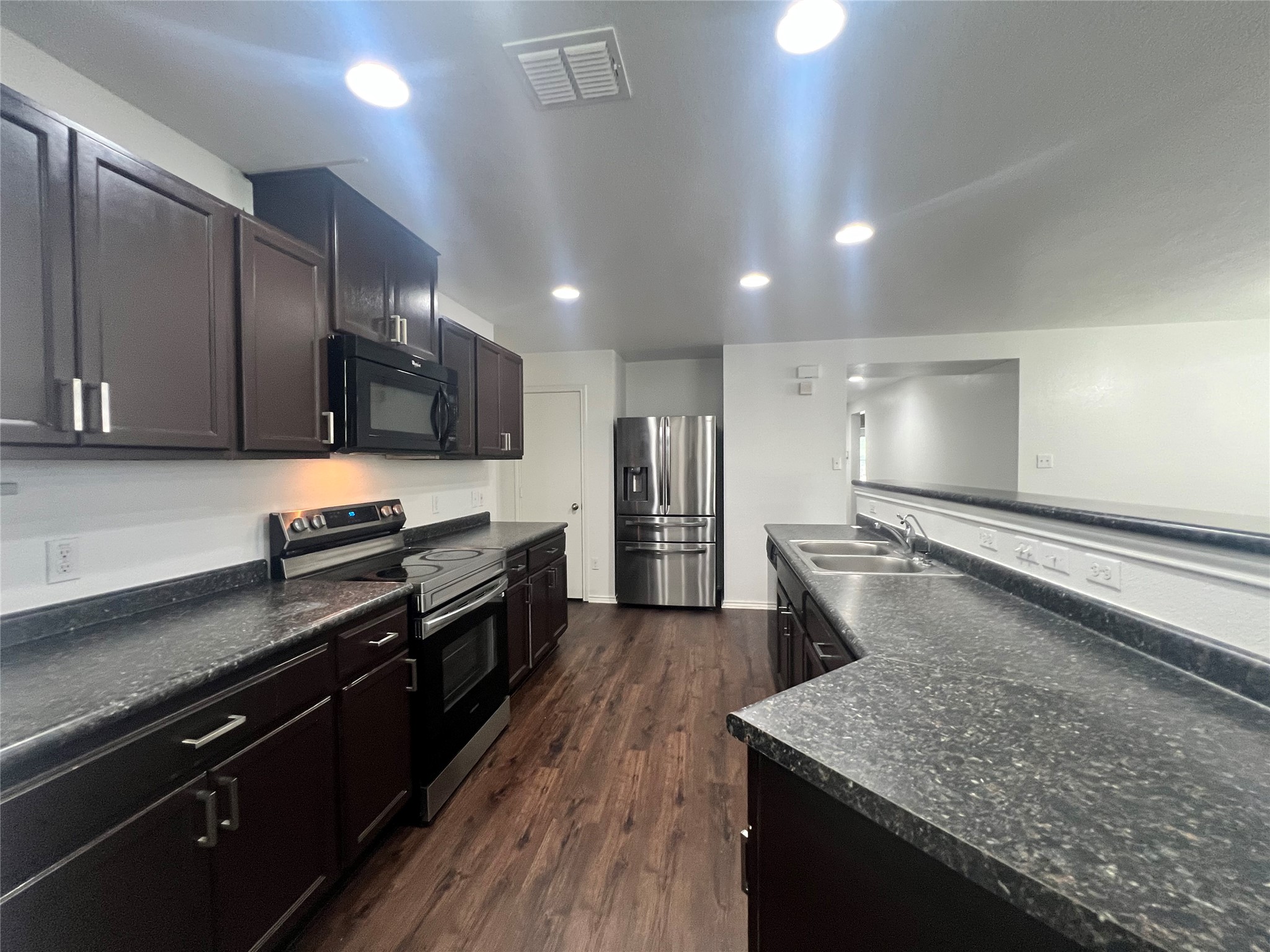 270 Sheep Trail Drive Kyle, TX 78640 - Photo 15 of 27 a large kitchen with stainless steel appliances