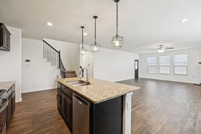 an empty room with windows and fireplace