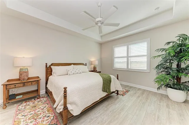 a bedroom with two beds and a chandelier