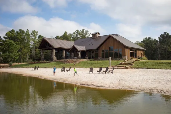 a view of a house with pool and chairs