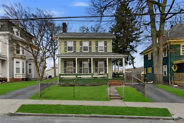 a front view of a residential apartment building with a yard