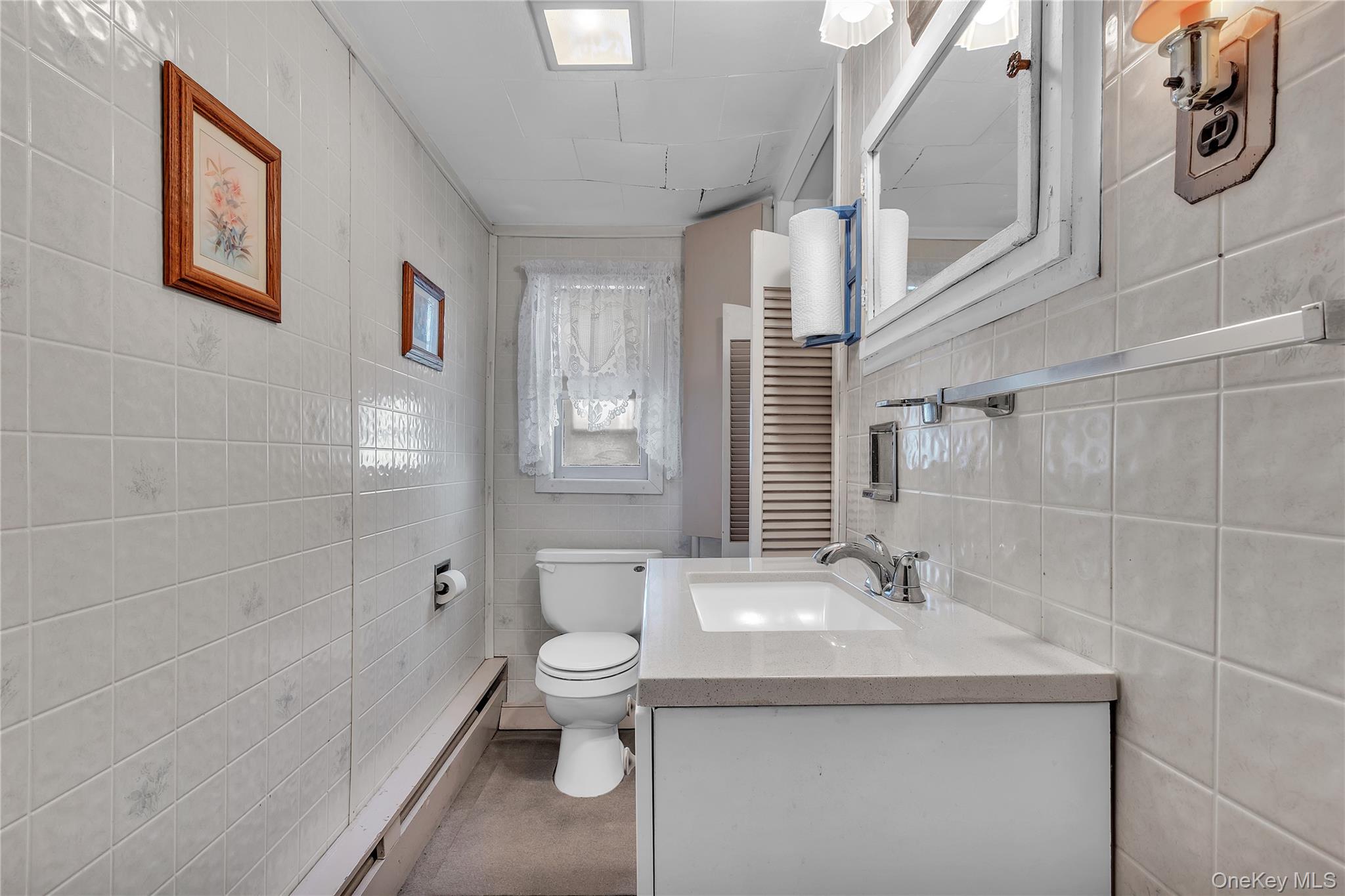 956 Paulding Street Peekskill, NY 10566 - Photo 13 of 27 a bathroom with a sink a toilet and shower