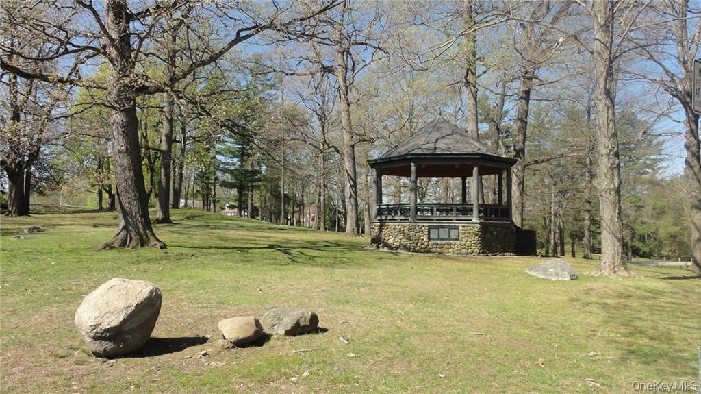 956 Paulding Street Peekskill, NY 10566 - Photo 24 of 27 a view of a garden with a bench and trees