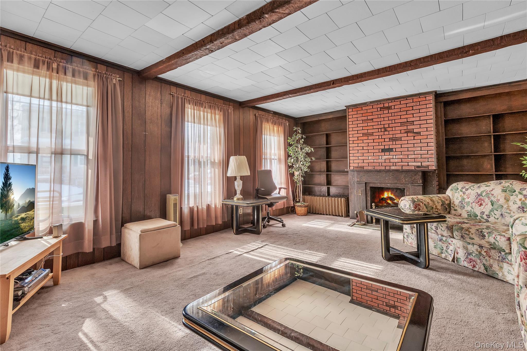 956 Paulding Street Peekskill, NY 10566 - Photo 3 of 27 a living room with furniture and a fireplace