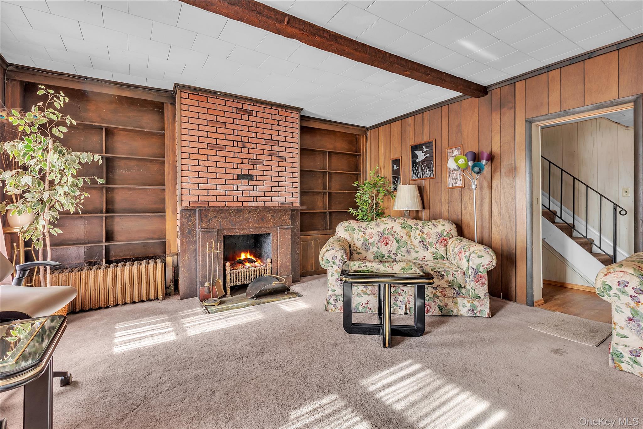 956 Paulding Street Peekskill, NY 10566 - Photo 4 of 27 a living room with furniture a fireplace and a flat screen tv