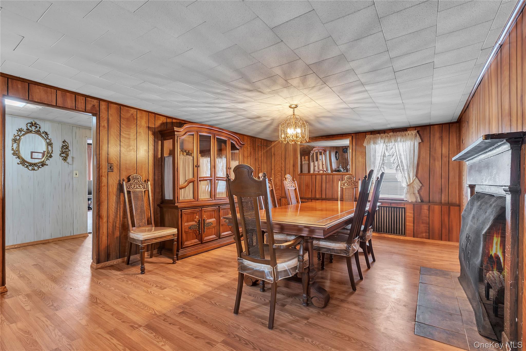 956 Paulding Street Peekskill, NY 10566 - Photo 6 of 27 a dining room with furniture a chandelier and wooden floor