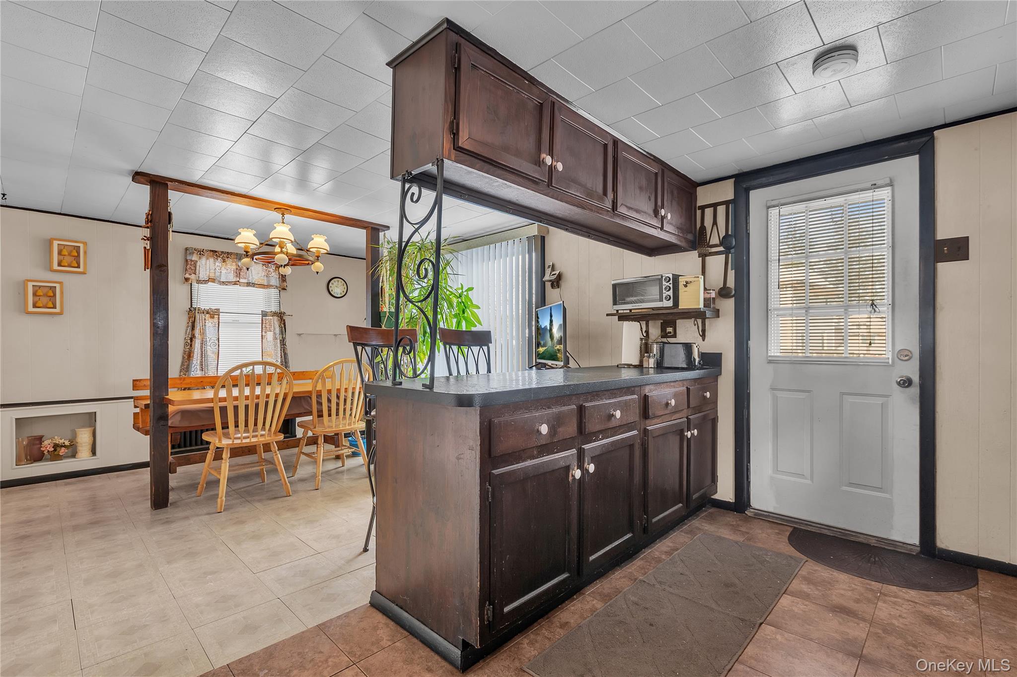 956 Paulding Street Peekskill, NY 10566 - Photo 7 of 27 a room with wooden cabinets and stainless steel appliances