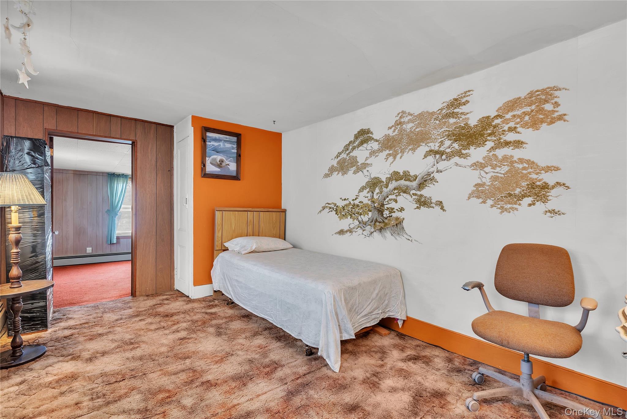 956 Paulding Street Peekskill, NY 10566 - Photo 10 of 27 a bedroom with a bed and a chair