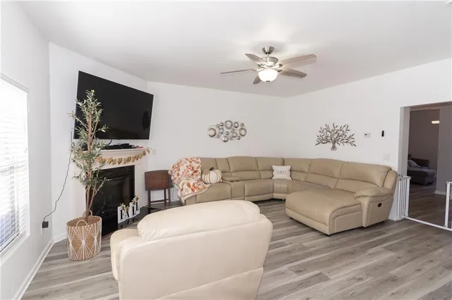 a living room with fireplace furniture and a flat screen tv