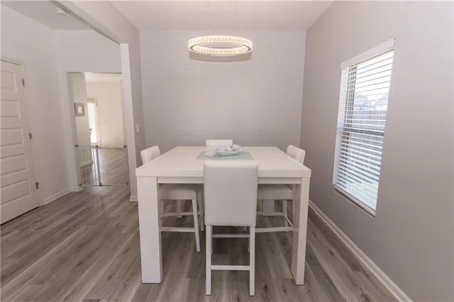 a dining room with furniture and wooden floor