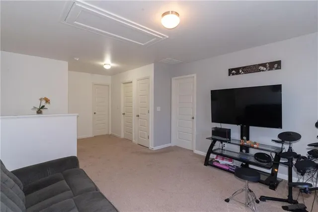 a view of a livingroom with workspace and a couch