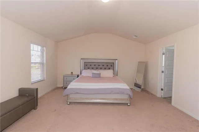 a bedroom with a bed and window