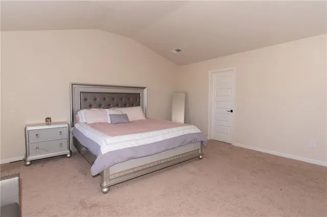 a bed room with a bed and white walls