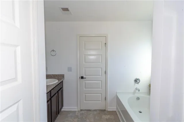 a bathroom with a bathtub and a sink