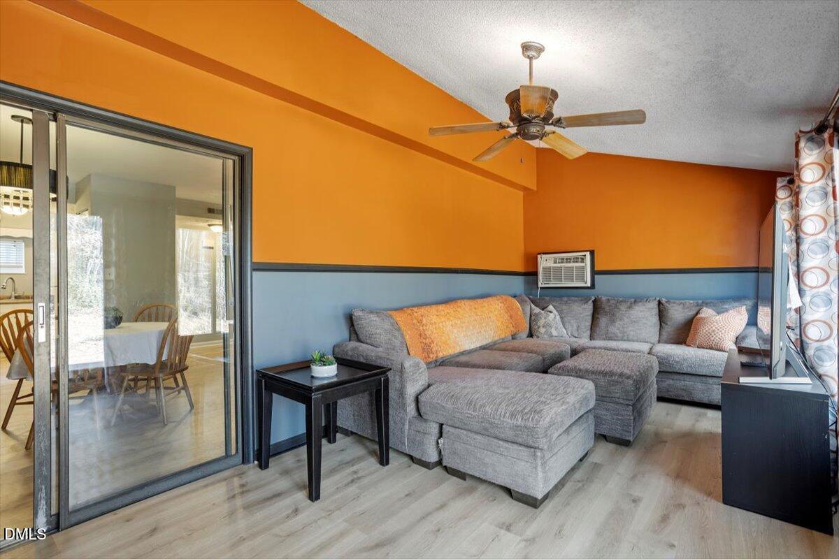 712 Godwin Court Raleigh, NC 27606 - Photo 6 of 27 a living room with furniture and a lamp