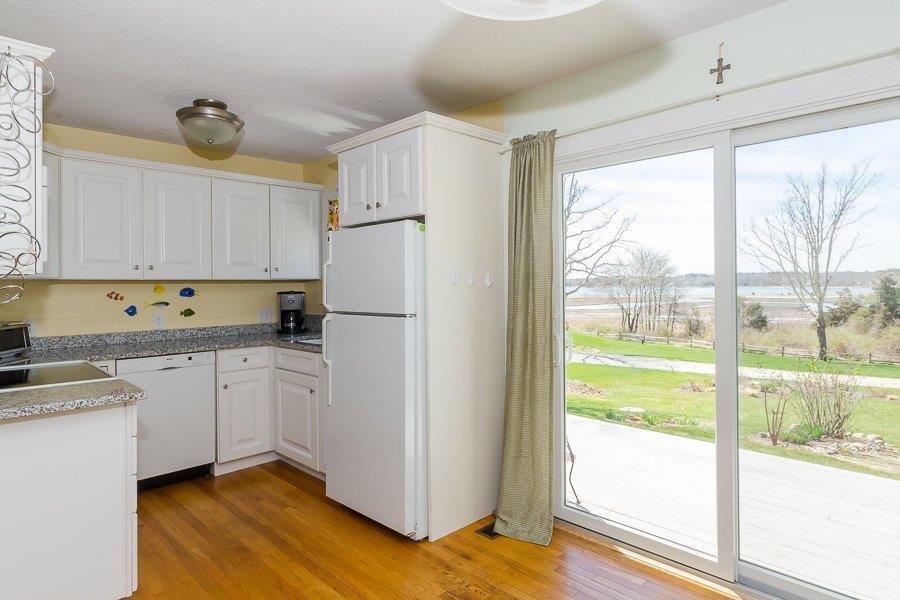 62 Converse Road Marion, MA 02738 - Photo 8 of 14 a kitchen with a refrigerator a stove a cabinets and wooden floor