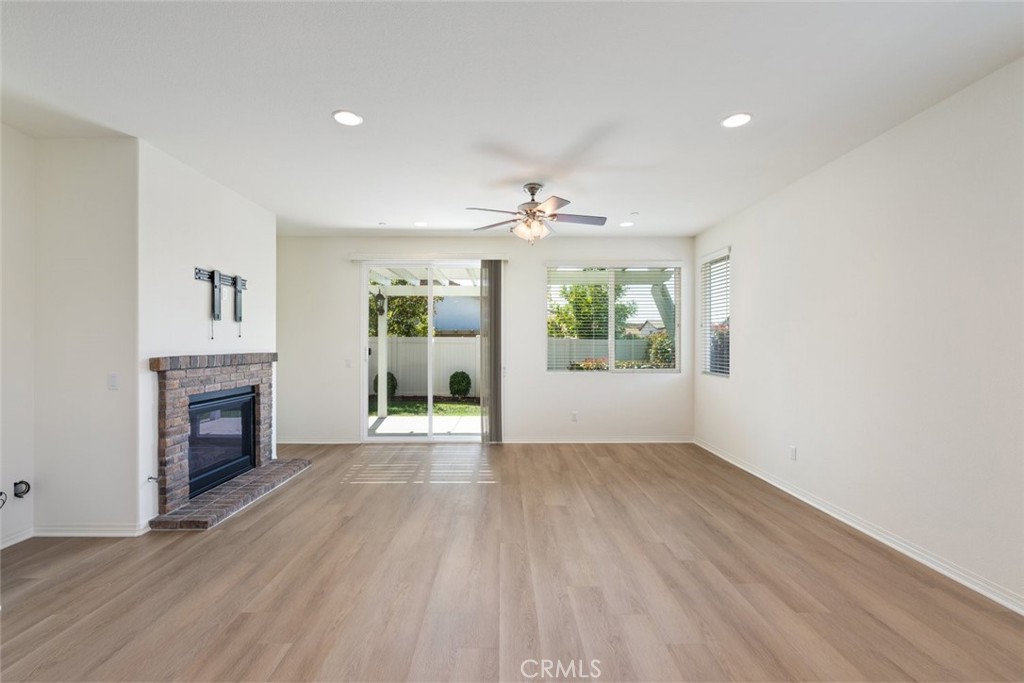 38121 Summer Ridge Drive Murrieta, CA 92563 - Photo 10 of 30 Family-Room with a Brick Mantle Fireplace and Slidding Doors leading to the beautiful Landscaped Backyard & Lattice Patio Cover.