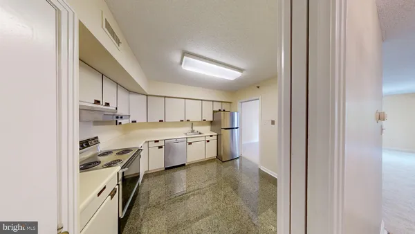 a kitchen with cabinets and a stove