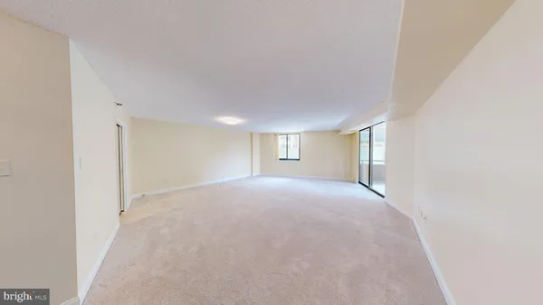 a view of hallway with closet and bathroom