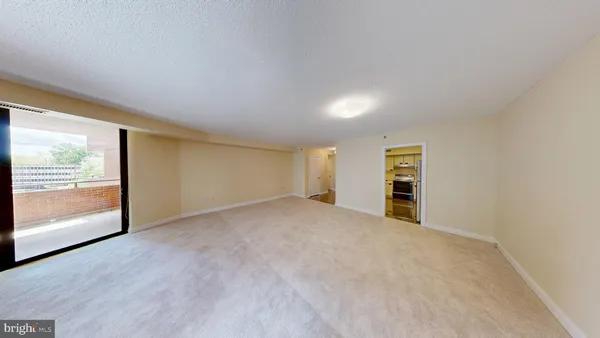 an empty room with windows and city view
