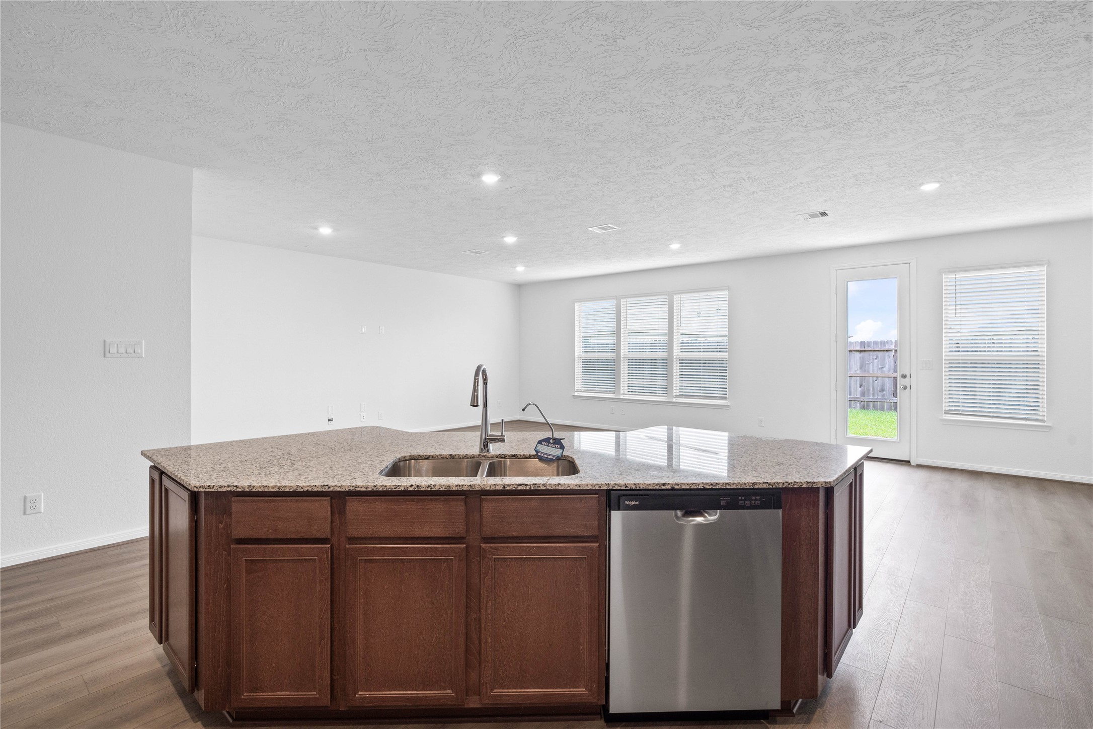 745 Imperial Loop Alvin, TX 77511 - Photo 19 of 29 a kitchen with granite countertop kitchen island with stainless steel appliances granite countertop a sink and window