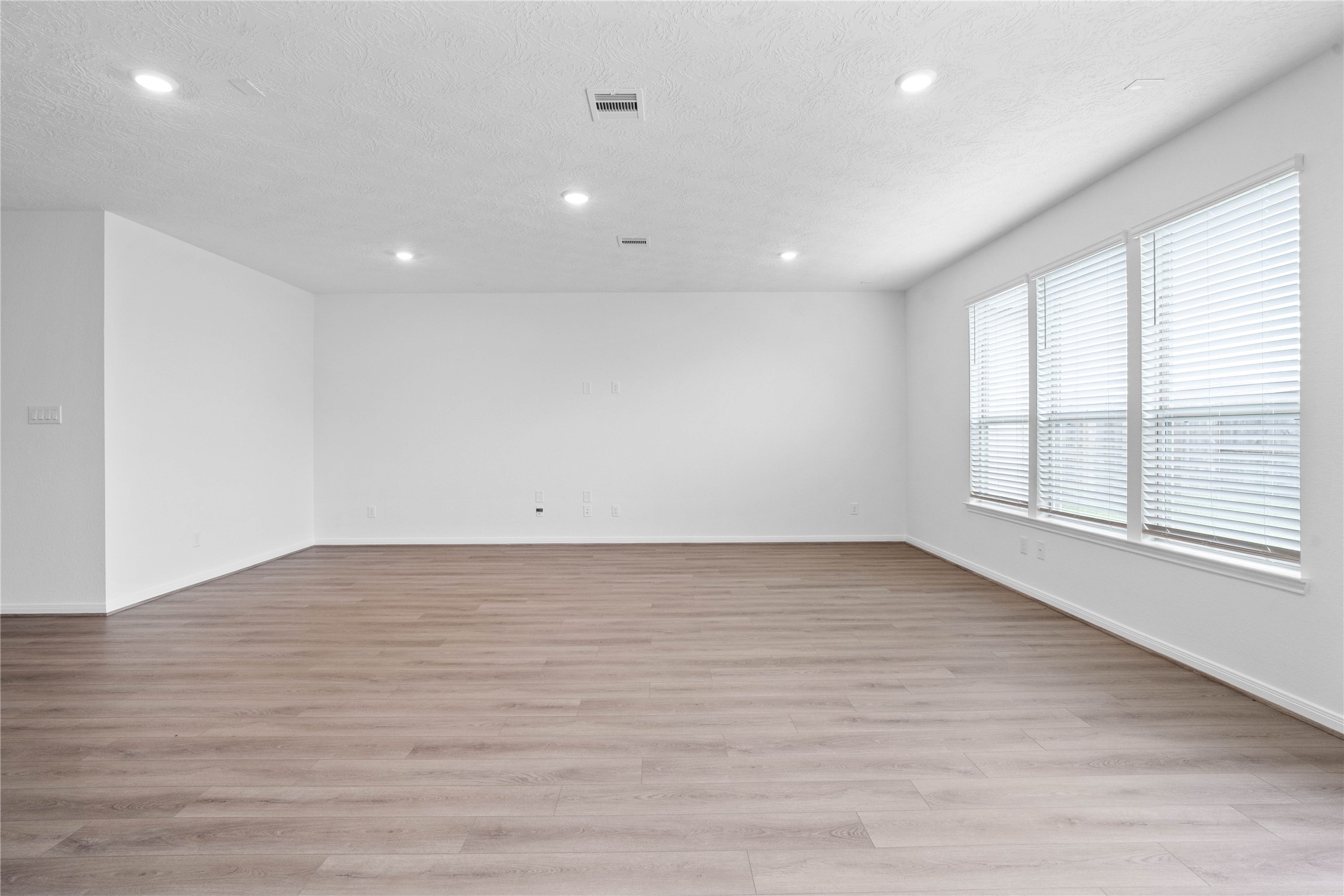 745 Imperial Loop Alvin, TX 77511 - Photo 21 of 29 an empty room with wooden floor and windows