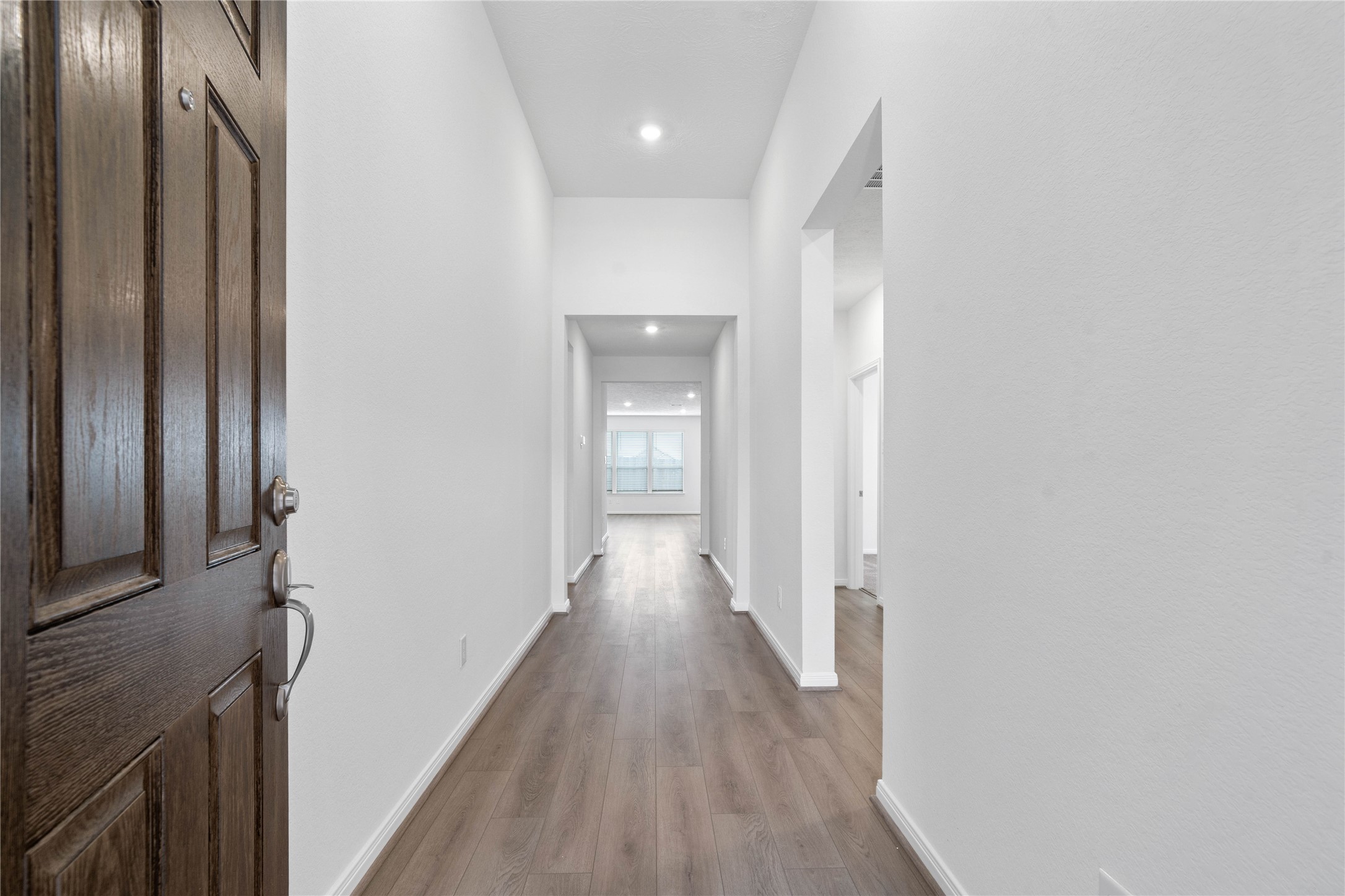 745 Imperial Loop Alvin, TX 77511 - Photo 4 of 29 a view of a hallway with wooden floor