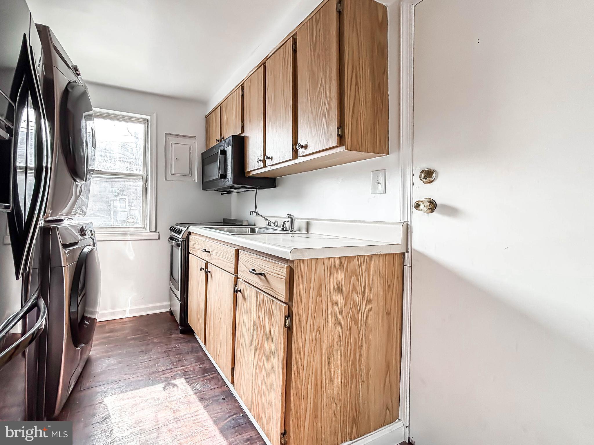 414 Avondale Road Dundalk, MD 21222 - Photo 13 of 33 a utility room with stainless steel appliances granite countertop a washer and dryer