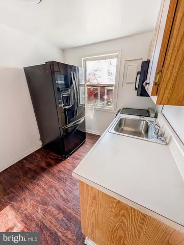 a kitchen with a refrigerator and a sink