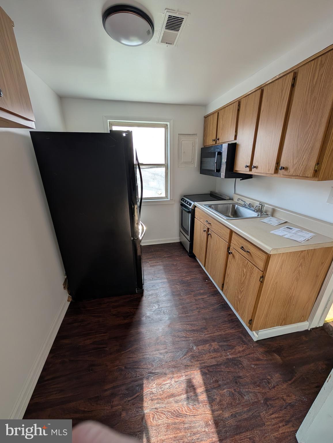 414 Avondale Road Dundalk, MD 21222 - Photo 14 of 29 a kitchen with stainless steel appliances granite countertop a stove a sink and a refrigerator