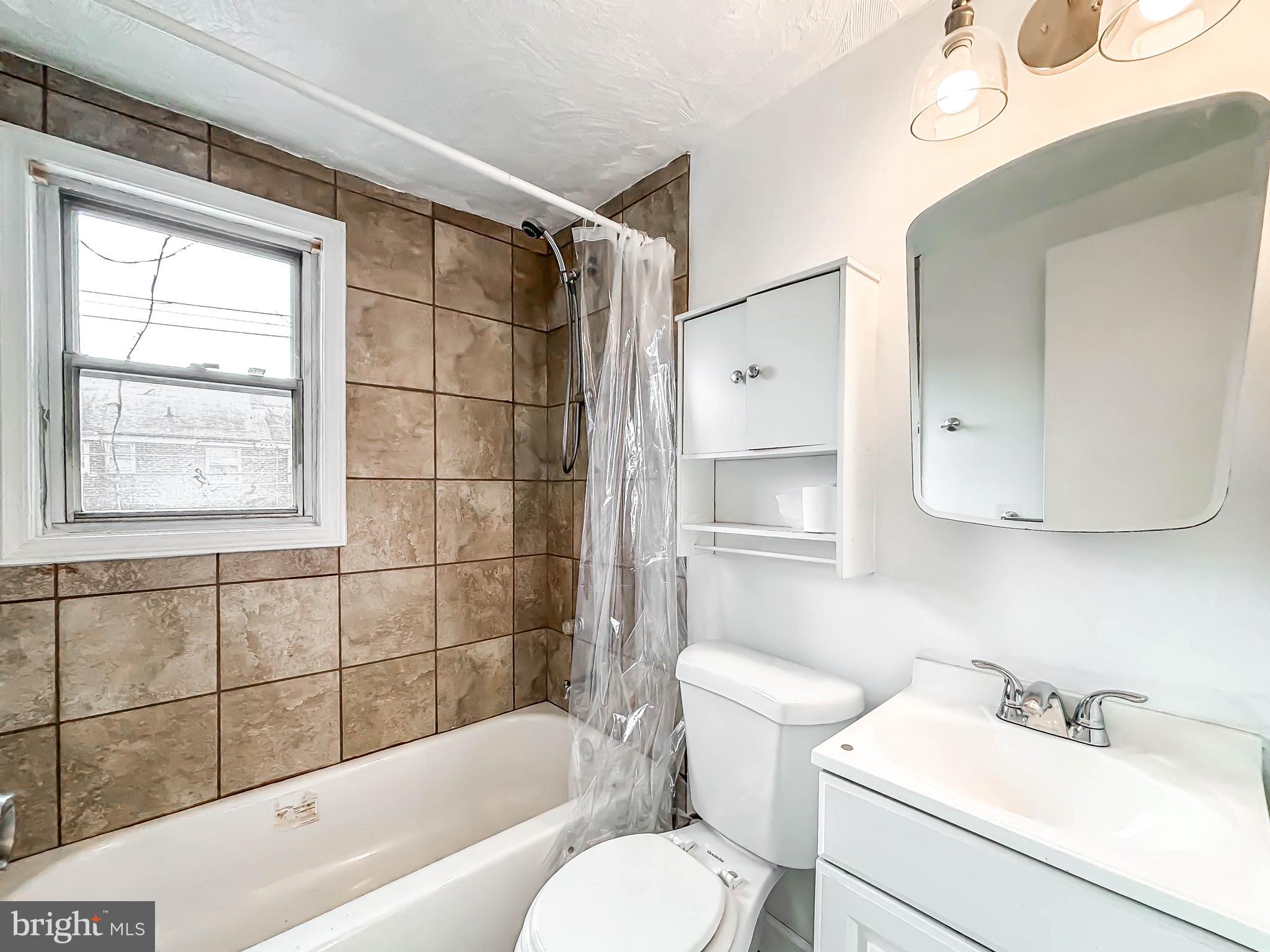 414 Avondale Road Dundalk, MD 21222 - Photo 16 of 33 a bathroom with a sink toilet and shower
