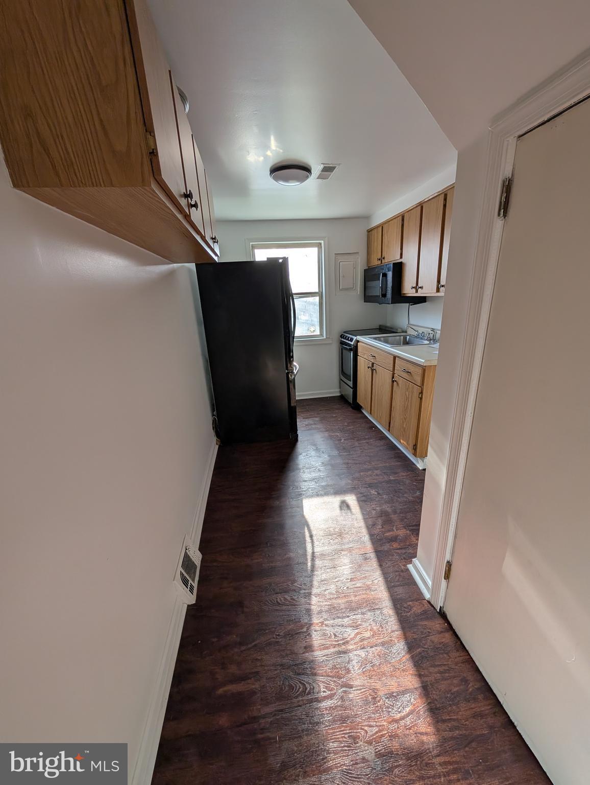 414 Avondale Road Dundalk, MD 21222 - Photo 18 of 29 a view of entryway and kitchen with wooden floor