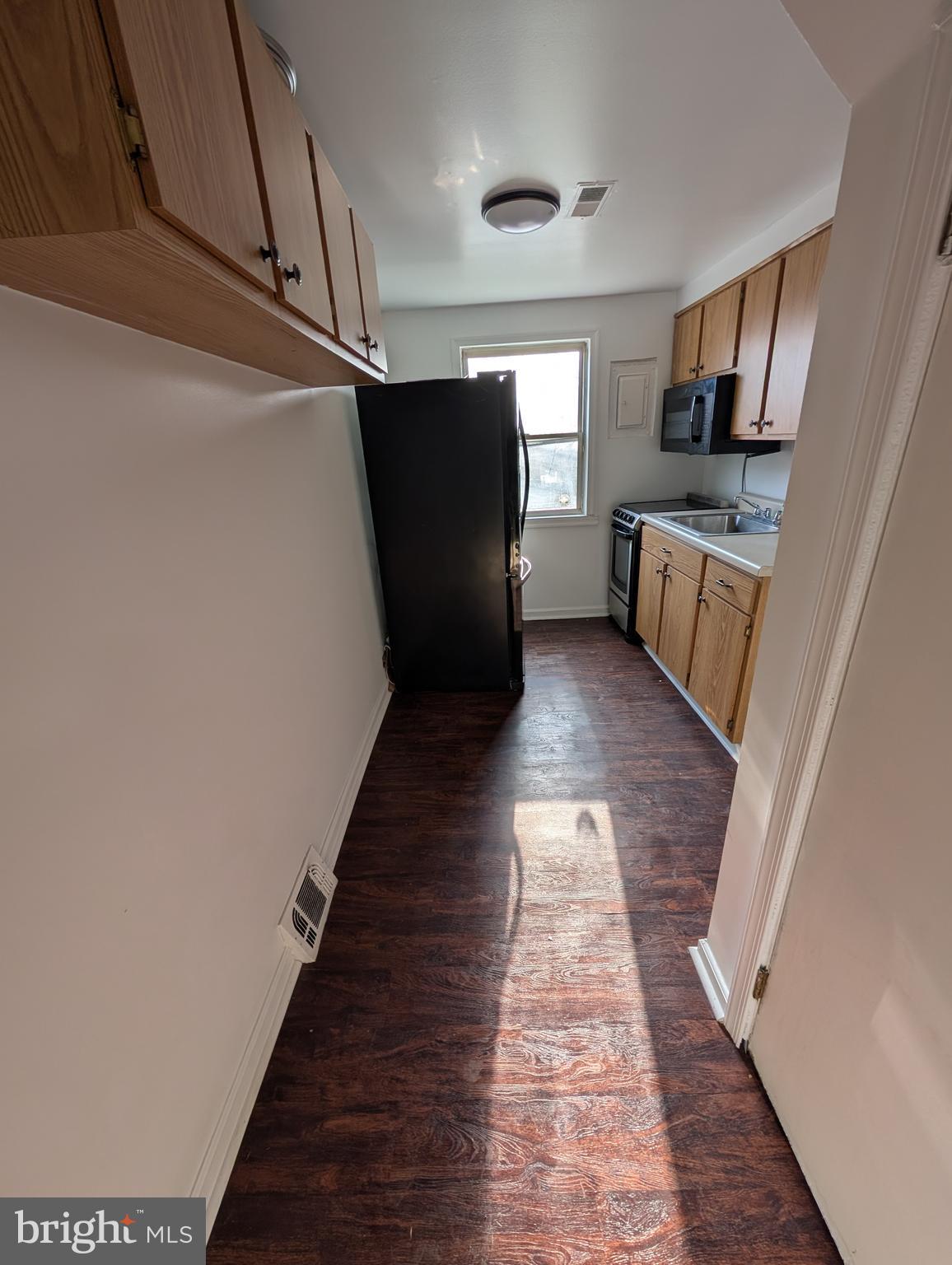 414 Avondale Road Dundalk, MD 21222 - Photo 20 of 29 a view of a hallway with wooden floor and staircase