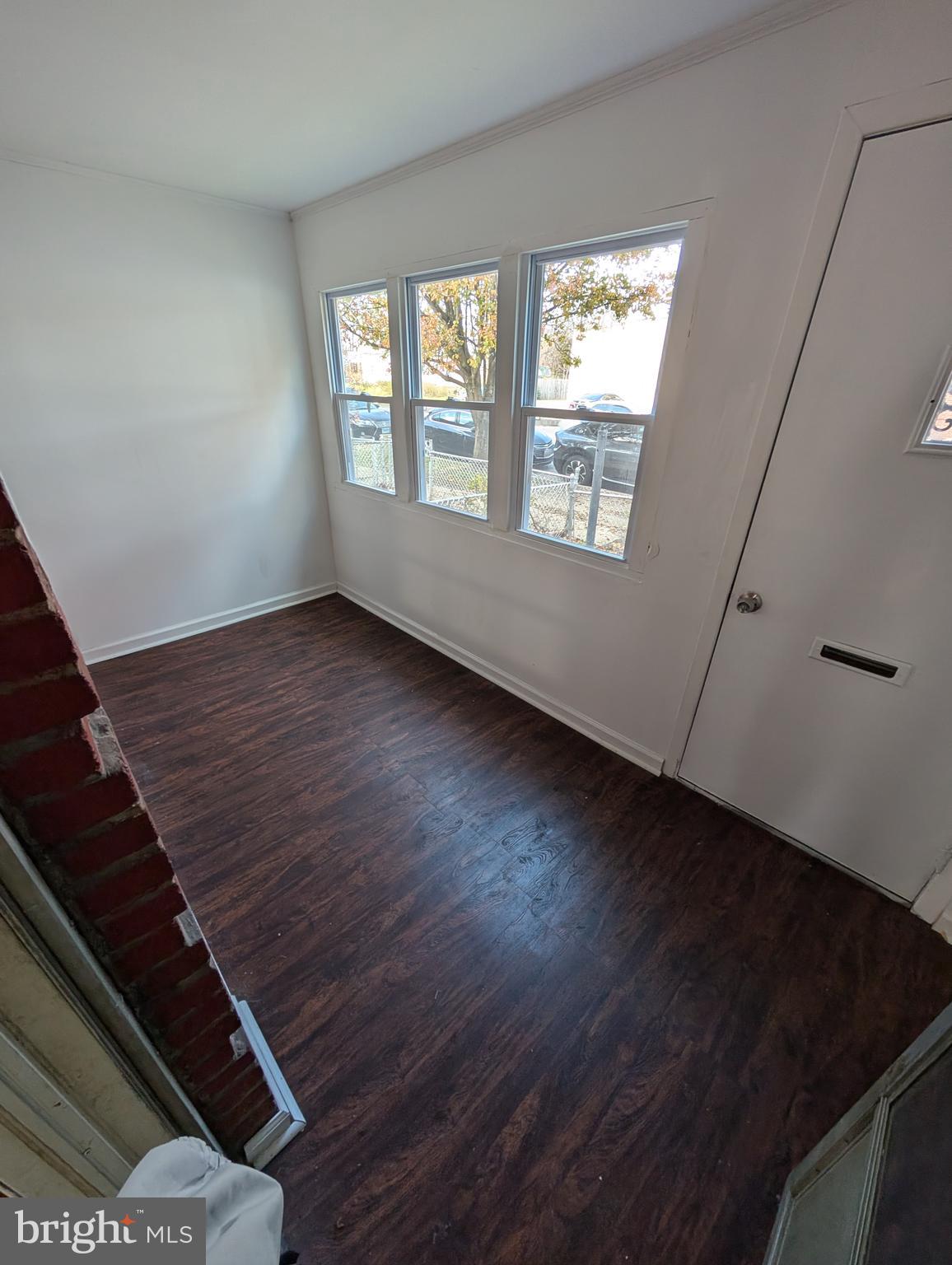 414 Avondale Road Dundalk, MD 21222 - Photo 21 of 29 a view of an empty room with wooden floor and a window