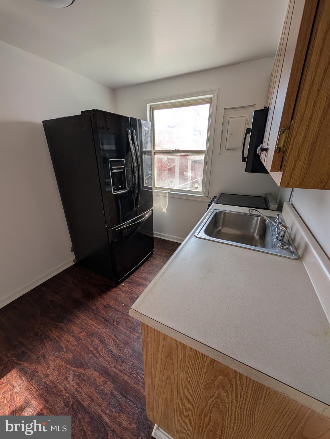 414 Avondale Road Dundalk, MD 21222 - Photo 3 of 29 a kitchen with granite countertop a refrigerator and a sink