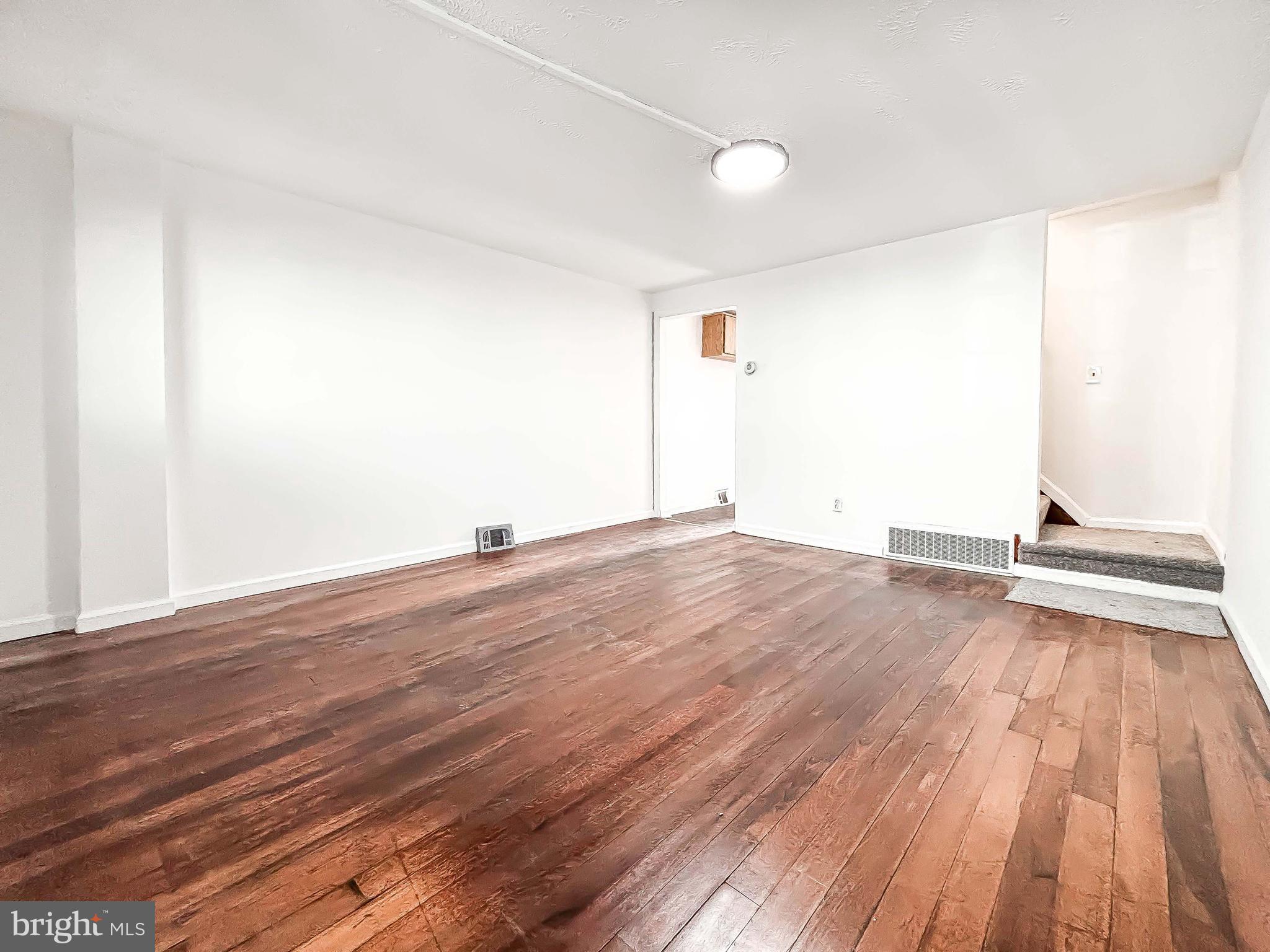 414 Avondale Road Dundalk, MD 21222 - Photo 6 of 33 a view of empty room with wooden floor