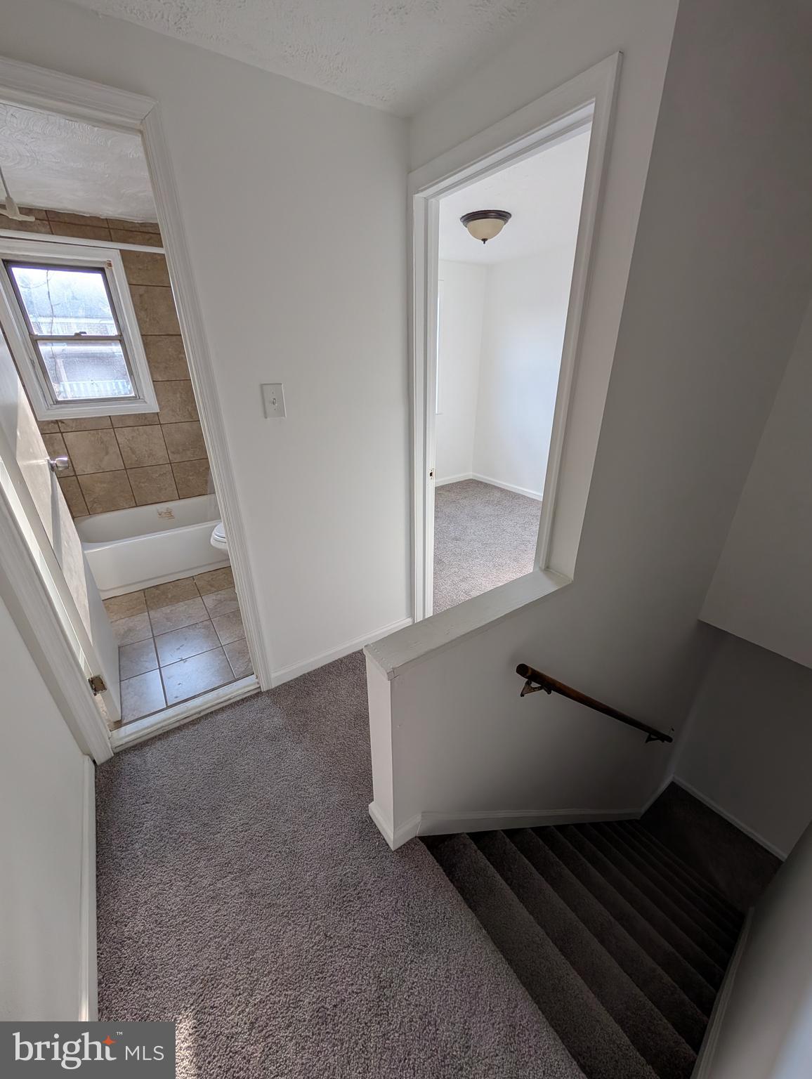 414 Avondale Road Dundalk, MD 21222 - Photo 7 of 29 a view of an empty room with wooden floor and a window